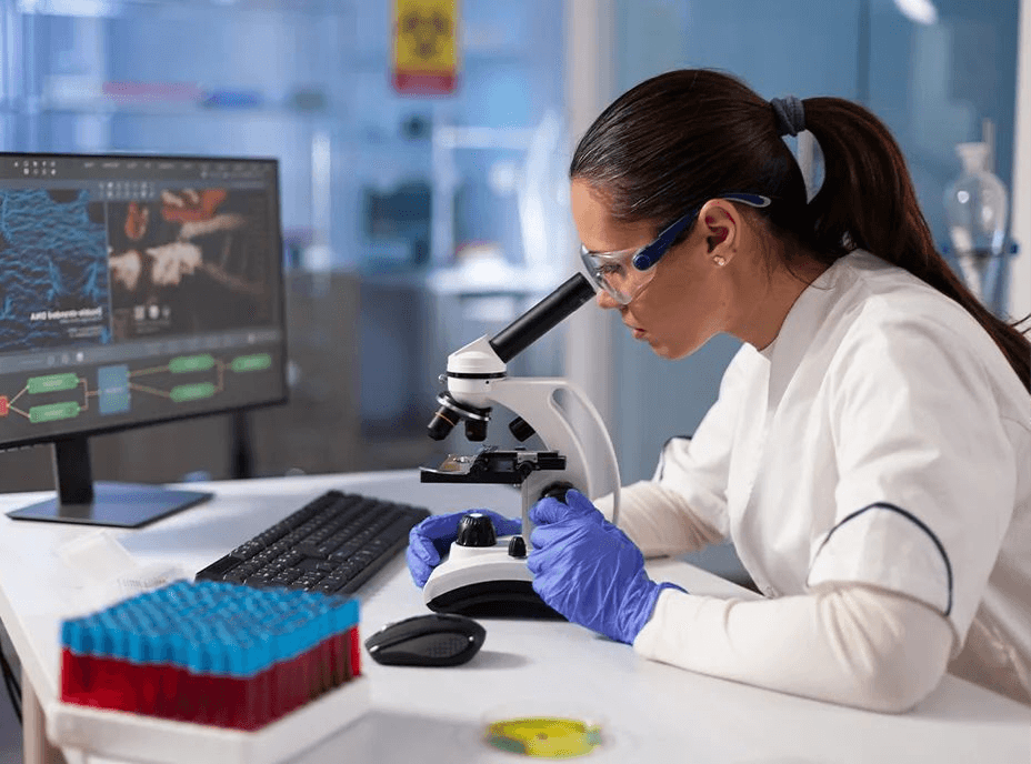 Research scientist analyzing blood samples under a microscope in the laboratory